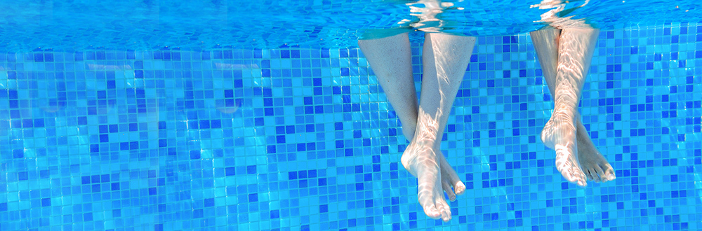 Feet at the Edge of a Pool